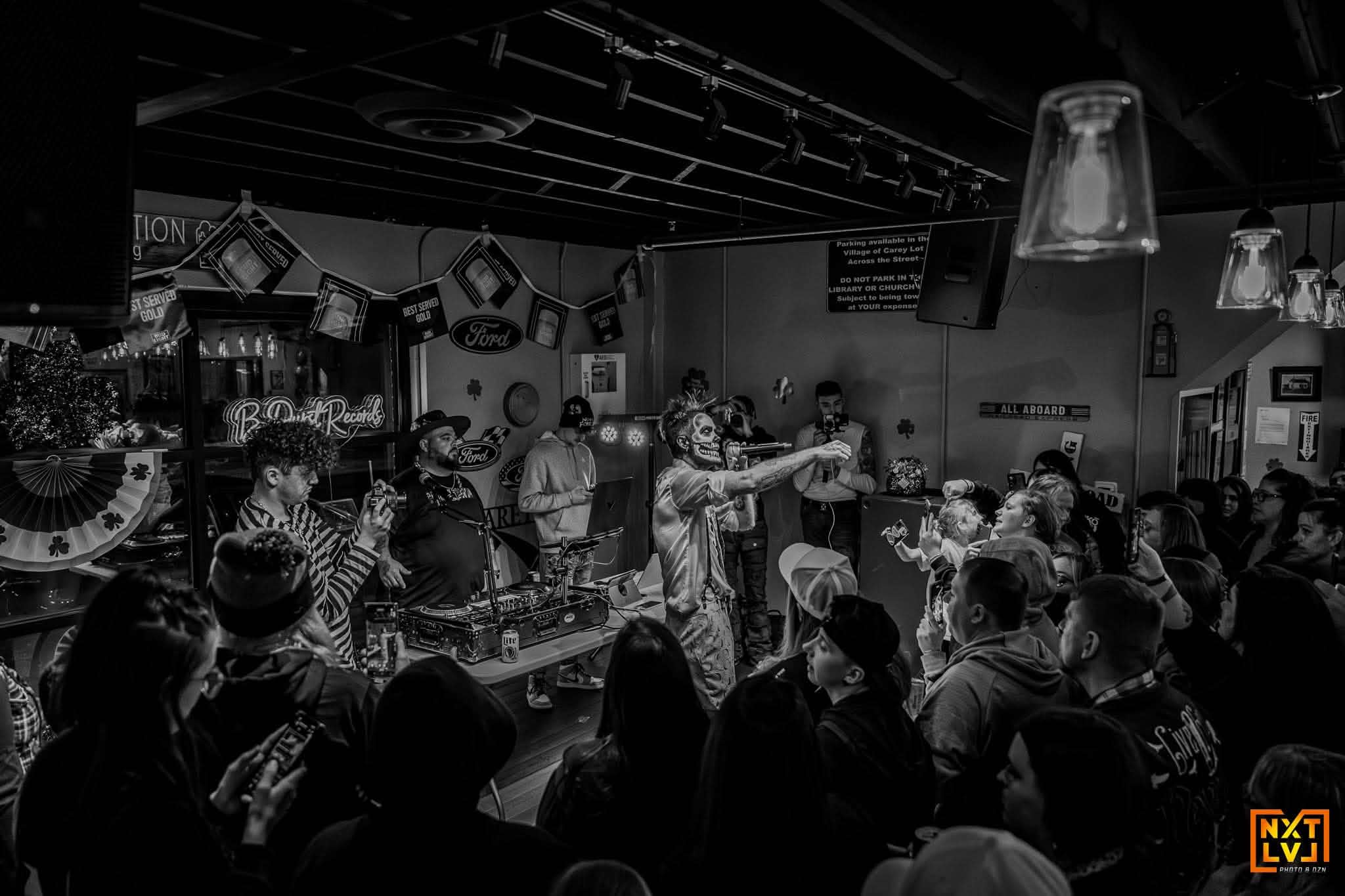 Black and white photo of Brian Durst performing in a packed venue.