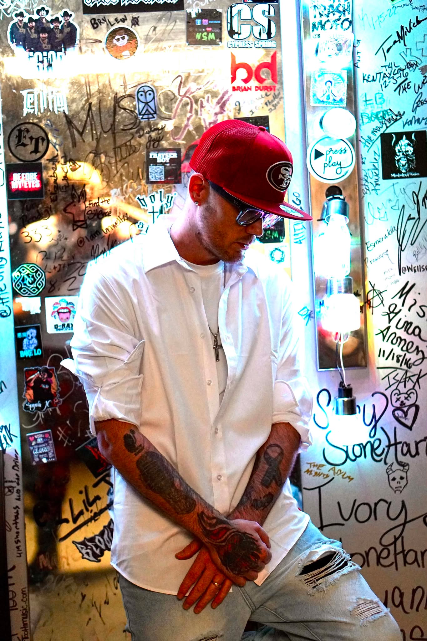 Brian Durst portrait by a signed venue wall.