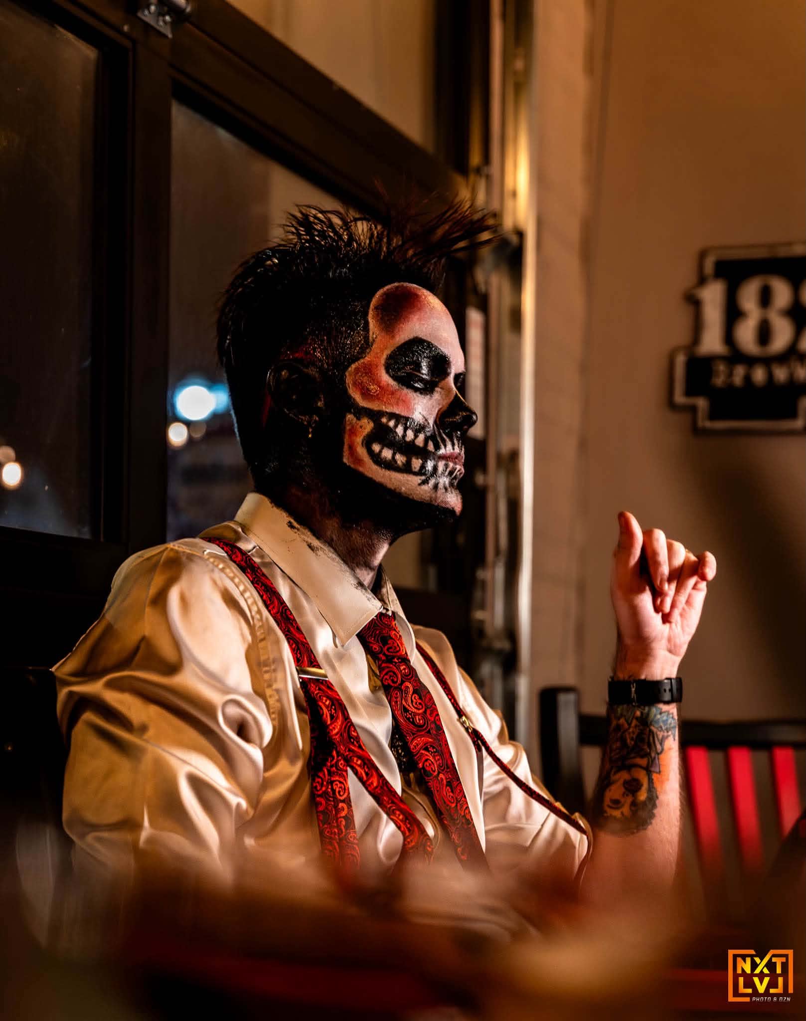 Brian Durst performing in skull makeup with a microphone.
