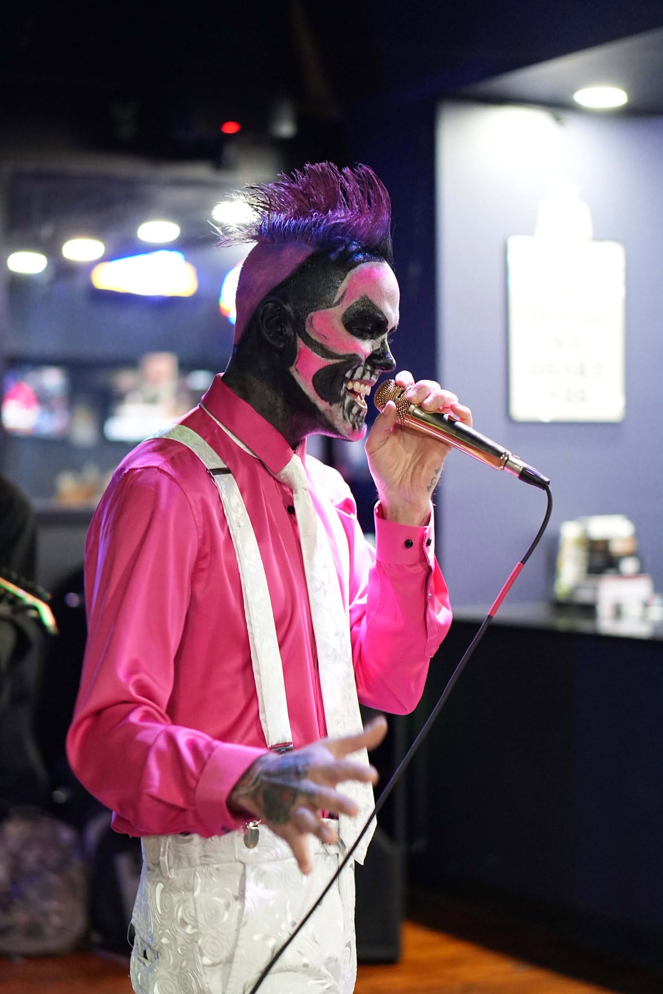 Brian Durst performing in skull makeup and a red jacket.